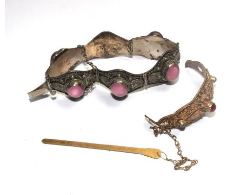 A Far Eastern bracelet in white colour metal set with pink stones in each panel together with a silver gilt bangle 