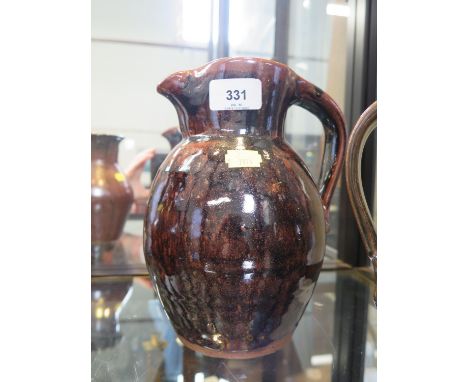 A Trevor Corser jug, with brown and black glaze, Leach Pottery and personal stamps, 22 cm high 