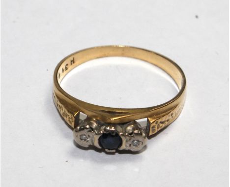 A three stone sapphire and diamond ring set in gold 