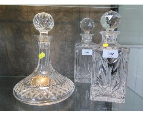 A cut glass ship's decanter, with silver wine label for Port, and a pair of square glass decanters 