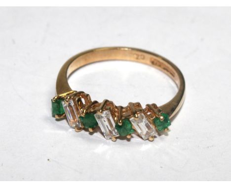 A seven stone ring set with emeralds and cubic zirconia 