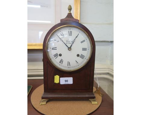 A Regency style mahogany and ebony strung mantel clock, Comitti of London, the domed case with painted dial and brass bracket