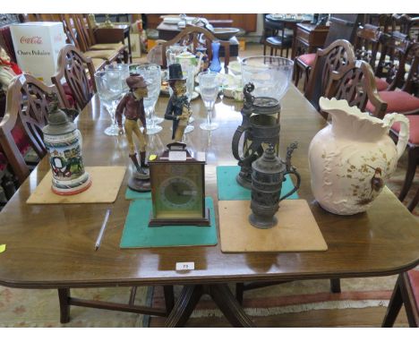 Three steins, two character figure candlesticks, a ceramic jug and a mantel clock (7) 