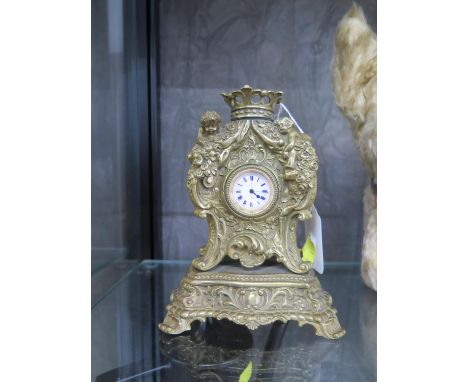 A gilded mantel clock with ladies fob watch movement together with two napkin rings, silver 