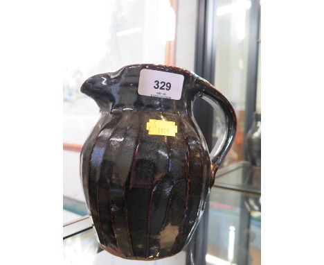 A Trevor Corser jug, with ribbed sides and brown glaze, Leach Pottery and personal stamps, 17 cm high 