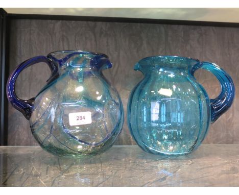 A vintage Murano clear art glass pitcher with swirl blue decoration together with another in plain blue colour 