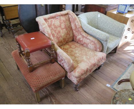 A late Victorian upholstered armchair, with downswept arms on ring turned legs and pot castors, another tub armchair and two 
