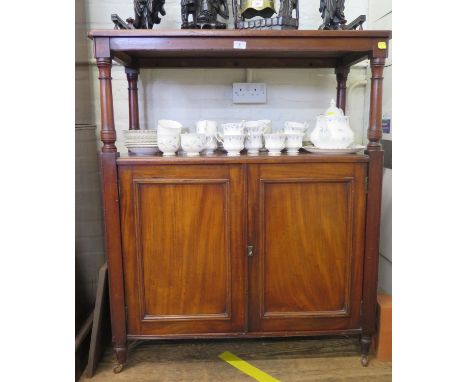 An Edwardian mahogany buffet, the gallery top over two tiers on turned supports above a pair of cupboard doors on pot castors