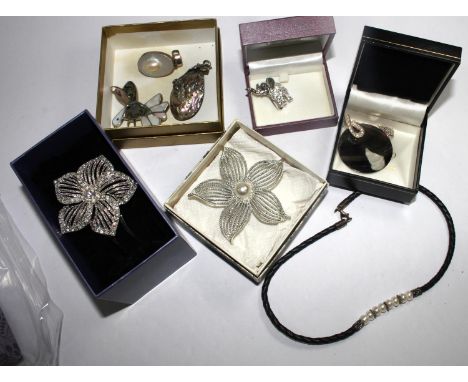 A bag containing necklaces, a bangle, brooches and pendants with mother of pearl, some silver mounted 