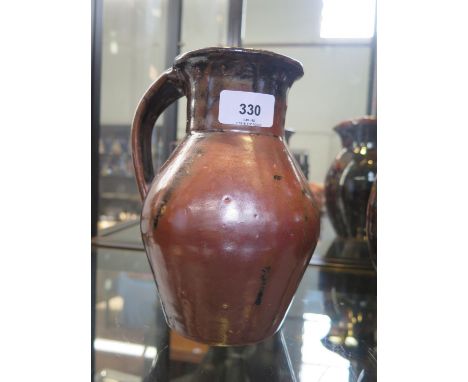A Trevor Corser single handled vase, with brown streaked glaze, Leach Pottery and personal stamps, 19.5 cm high 