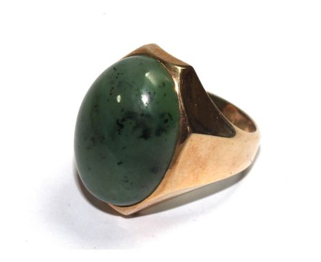 A gentleman's 14 carat gold ring set with possibly a jade stone 