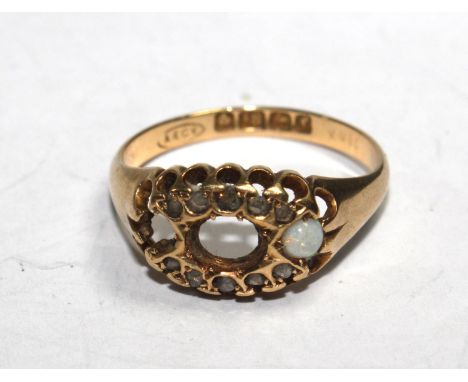 A ladies gem set ring in 18 carat gold (two stones missing) 