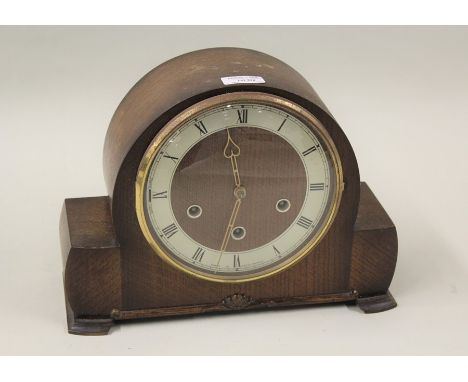 A Smiths Westminster chiming oak mantel clock, complete with instructions and guarantee dated January 1958