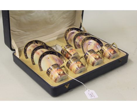Noritake coffee set, decorated with a desert scene with figures on camels and pyramids, consisting of five coffee cups and si