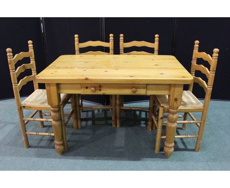 Pine dining table on turned legs, 122cm x 80cm together with four pine ladder back dining chairs with rush seats (5)