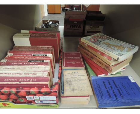 A shelf of early to mid 20th century British Railway and LMS time table etc