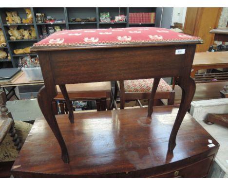 A traditional stained frame piano stool