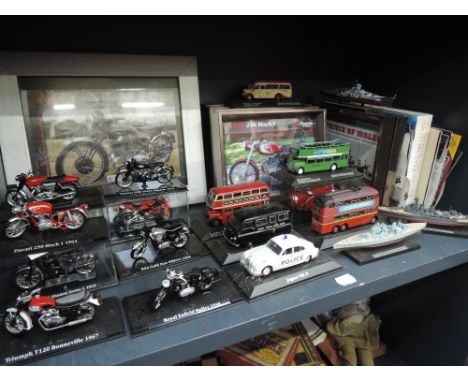 A shelf of Atlas die-cast vehicles and relating pictures and paperwork including motorcycles, buses etc