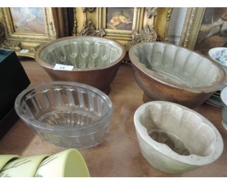 Three ceramic and one glass vintage jelly mould including lion shaped pattern