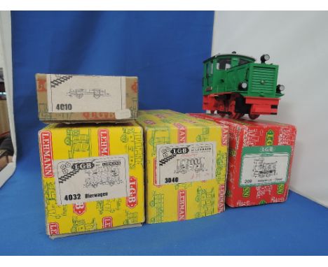 An LGB G scale 0-4-0 plastic model tank engine and three carriages and flat wagons, all boxed