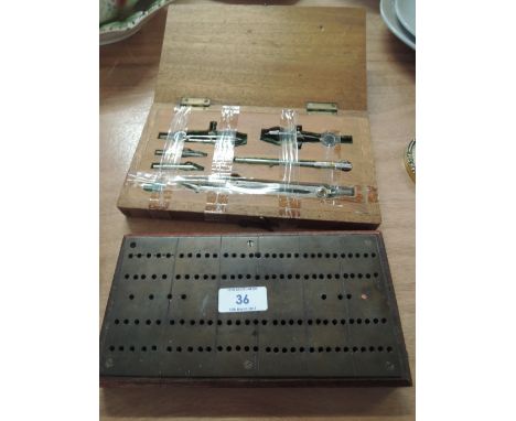 A treen boxed set of compasses and a cribbage board