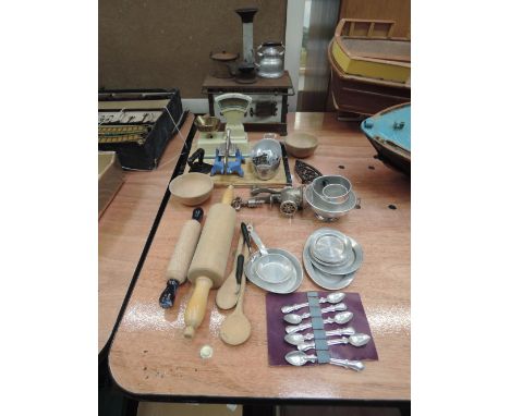A selection of vintage miniature kitchen wares including a tin plate German stove, tin plate kitchen scales, wooden rolling p
