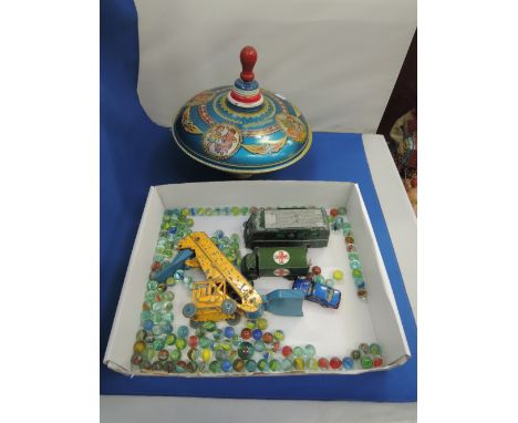 A mid 20th century Fuchs Melodius spinning top, a selection of vintage marbles and four Dinky military die-cast vehicles
