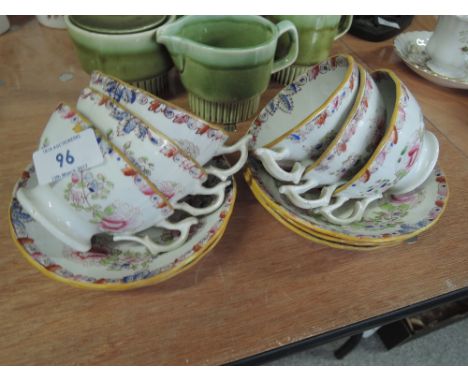 A set of six cups and saucers in floral and bird of paradise design
