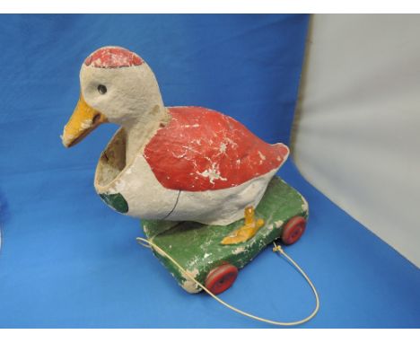 A vintage home made papier mache pullalong duck having moving head
