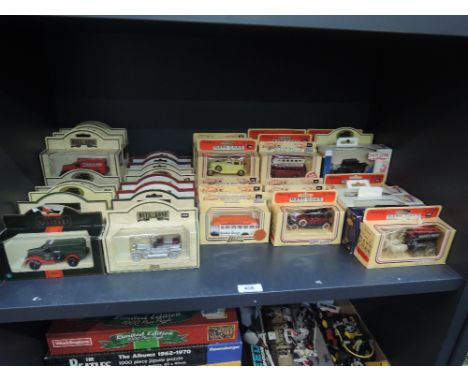 A shelf of Lledo Days Gone die-cast vehicles, all in card window display boxes