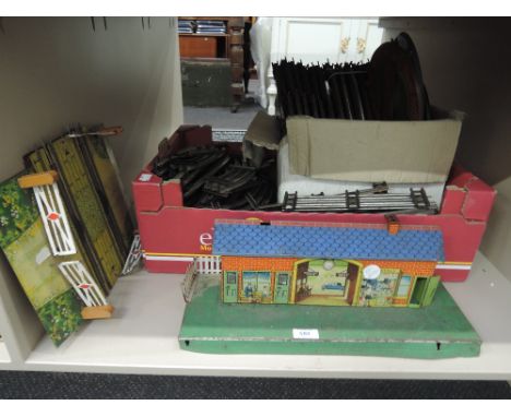 A shelf of Hornby 3 rail track, paints, level crossing, station buildings etc