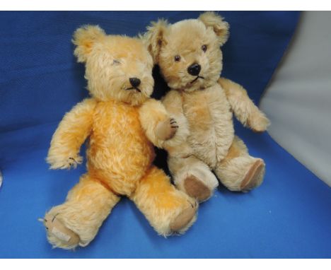 Two mid 20th century straw filled yellow plush Chiltern teddy bears having plastic eyes, plastic and stitched noses, stitched