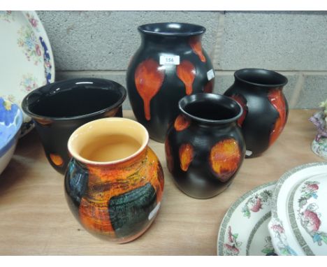 Four Poole Pottery vases and a planter