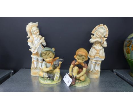 A pair of oversized Hummel style boy and girl figures and a pair of Continental bisque figures (4)