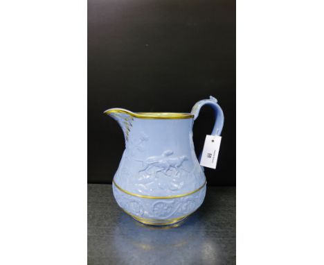 Pale blue glazed hunting jug, in the manner of Dudson, with hounds and foliate pattern in relief, 22cm high