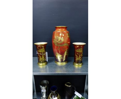 W & R Carlton Ware rouge glazed vase garniture, gilt decorated with dragon pattern, comprising tall baluster vase, pattern nu