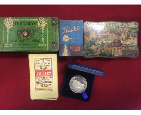 An album of 48 postcards, mainly northern topographical; a Cremona tin with 1929 NE Exhibition to lid; a cigarette tin; an Ed