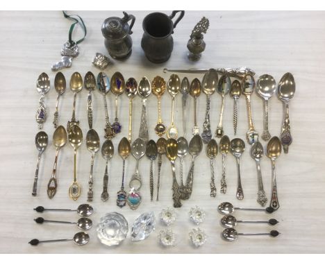 A collection of 35 novelty silver spoons including several enamelled, mainly American and European cities, gold plated, sterl