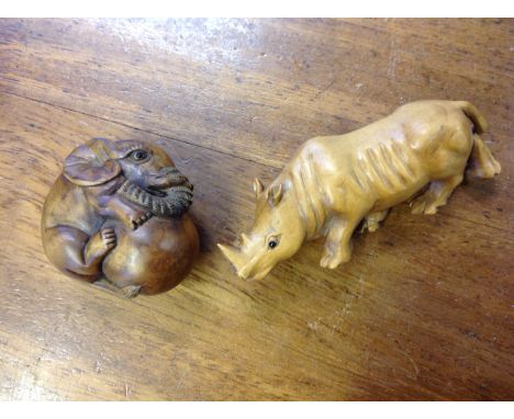 A carved hardwood netsuke depicting a baby elephant with ball, having inlaid bead eyes - signed two character mark; and anoth