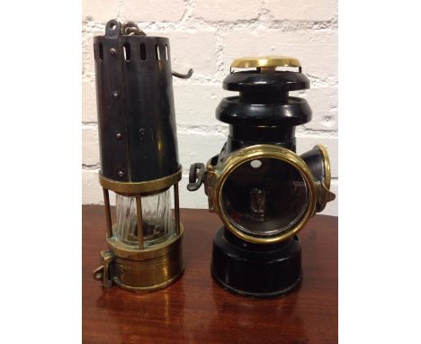 A Richard Johnson Clapham & Morris miners lamp with tapering numbered chimney above a rippled glass enclosure framed by five 