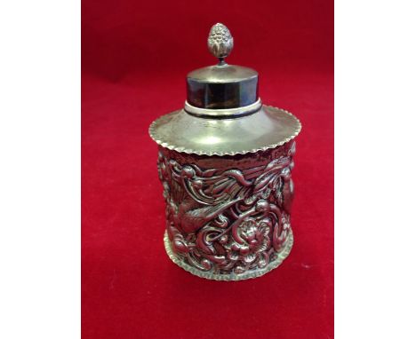 An Edwardian hallmarked silver caddy & cover, the tubular vessel embossed with birds, flowers, stylised masques and scrolling