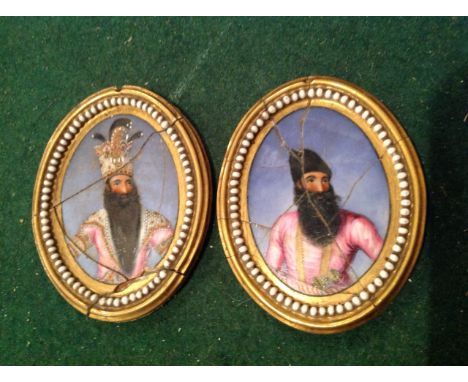 A pair of eastern bust miniatures, the enamelled ovals painted on ceramic depicting bearded figures on blue ground, the gilt 