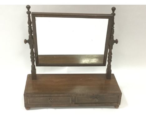 A nineteenth century Bullock style rosewood dressing table mirror, the cushion moulded frame on ring-turned supports above a 