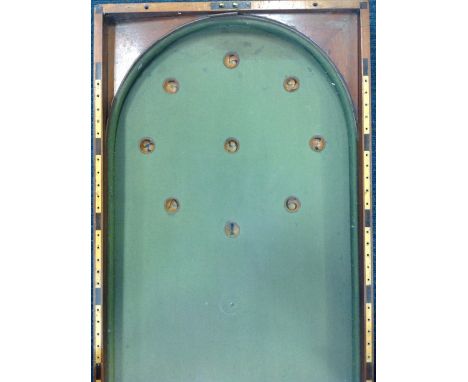 A nineteenth century mahogany bagatelle board, the rectangular case with baize lining and cushions, the holes numbered with i