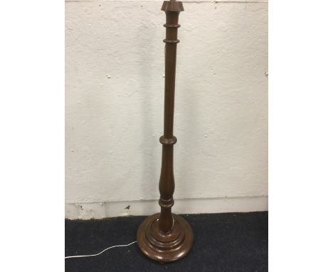 A Victorian mahogany standard lamp, with heavy bulbous turned column raised on circular moulded base. (55in)