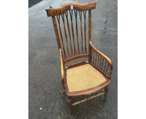 An unusual scumbled hardwood armchair, with yoke style back rail above twisted stick slats, having downsloped arms on columns