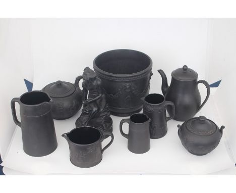 A collection of Wedgwood black basalt ware comprising; wine bucket, coffee pot, teapot, jugs; a figure of psyche which is AF,