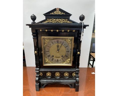 A late 19th Century Gothic Revival style ebonised bracket clock, square brass dial with silvered chapter ring, Roman numerals