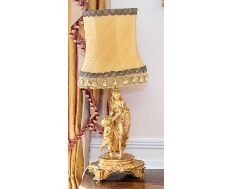 &nbsp;A French ormolu figural table lamp, 19th Century, modelled as a neoclassical maiden in flowing robes accompanied by a y