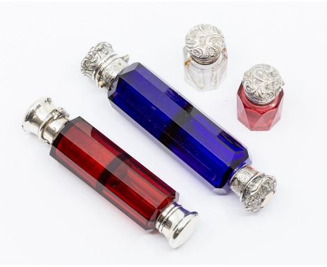Two Victorian white metal capped double ended ruby and blue glass scent bottles, a further pair of miniature ink pots, one ru